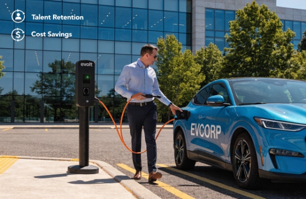 Employee plugging in an EV at a workplace parking lot charger station, illustrating corporate charging benefits