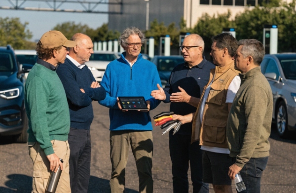 Fleet operators checking and comparing different EV plug types for multi-vehicle compatibility